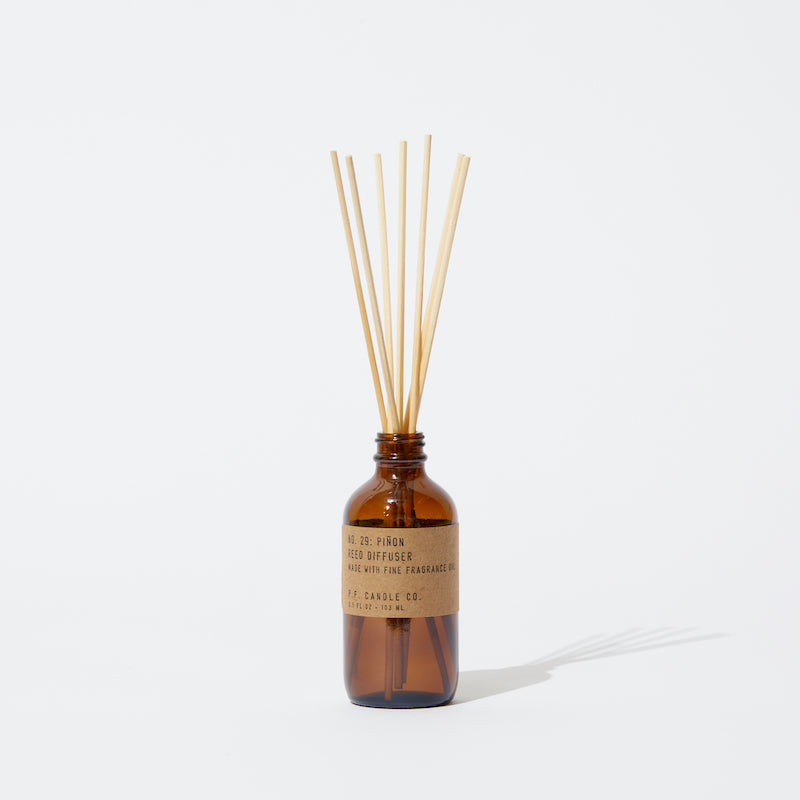 P.F. Candle Co. Piñon Reed Diffuser - Product - Our Reed Diffusers come in apothecary-inspired amber glass bottles with our signature kraft label and rattan reeds. Low-maintenance scent throw, all day long - no match necessary.