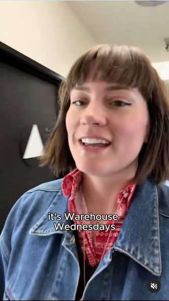 A woman wearing a red shirt under a denim jacket, exuding a relaxed and fashionable vibe.